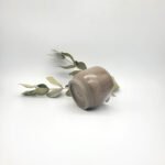 Underside view of a handcrafted dark stoneware mini pitcher showing the unglazed foot ring and maker's mark